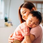Happy mother and hugging embracing little son with love and care